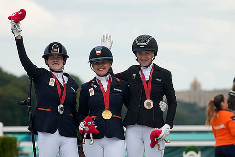 Paris Paralympics 2024 Equestrian individual grade IV: Demi Haerkens, centre, Sanne Voets, left, and Anna-Lena Niehues pose with their gold, silver and bronze medals 